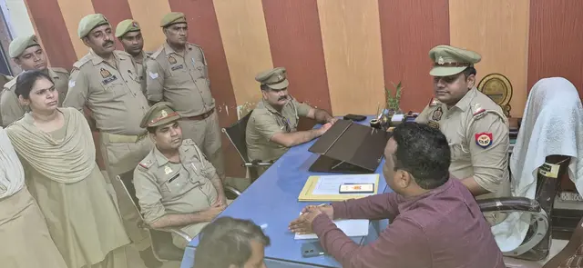 Certsure auditor briefing police officers and staff seated around a desk during an ISO audit at a police station