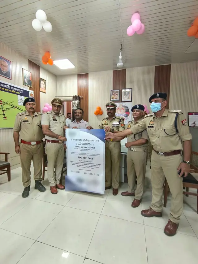 Railway police officers at Thana GRP Saharanpur holding the ISO 9001:2015 Certificate of Registration for the station’s quality management system